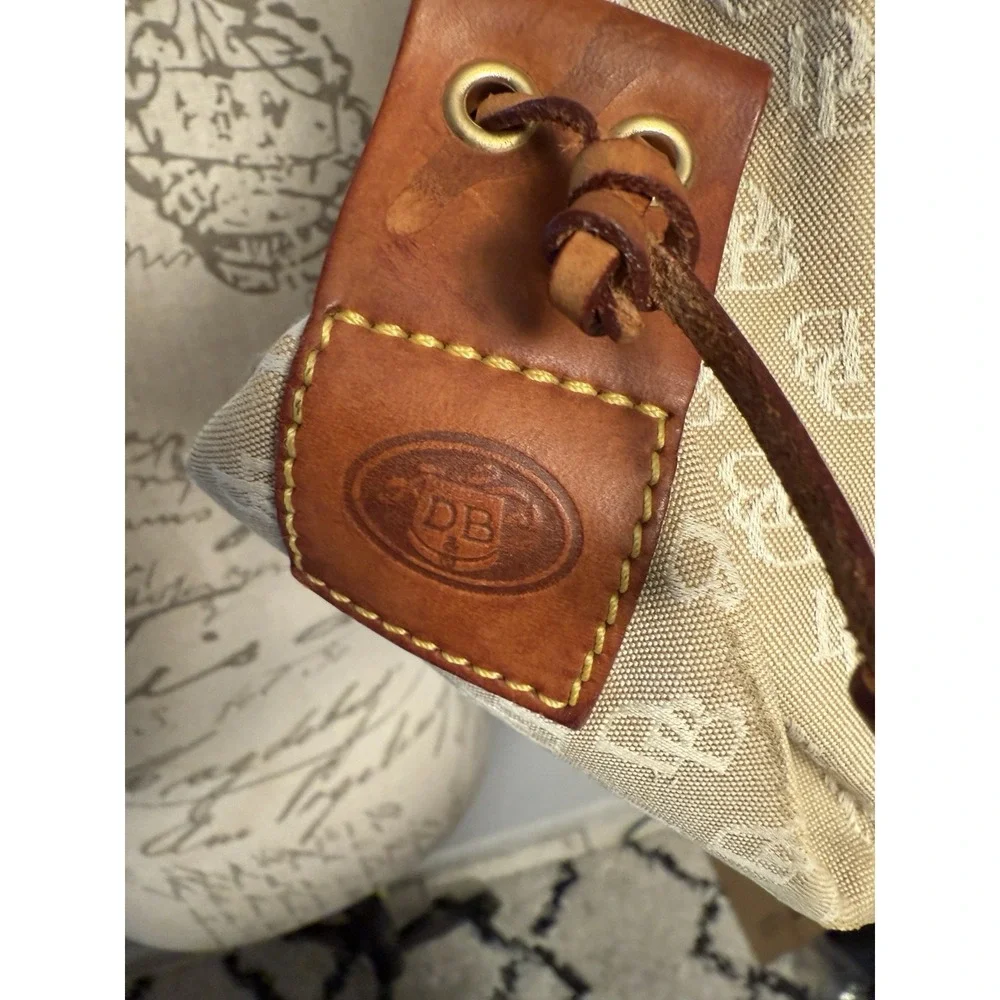 Dooney and Bourke Beige Canvas and Leather Signature Tassel Tote Handbag‎